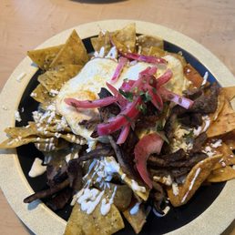 CHILAQUILES with steak, half green/half red sauce