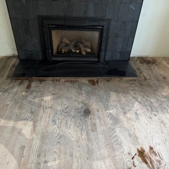 Omega Tile Marble & Granite - This is his sloppy tile work. Black grout water all over my brand new unfinished hardwoods. - General Contractors Near Me - Bellevue, Washington Omega Tile Marble & Granite - This is his sloppy tile work. Black grout water all over my brand new unfinished hardwoods. - General Contractors Near Me - Bellevue, Washington