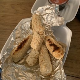 a plate of breadsticks and dipping sauce a plate of breadsticks and dipping sauce