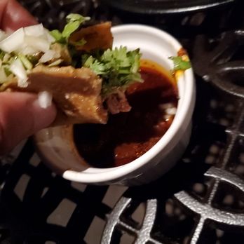 La Dama - Consomme for the lamb birria taco (I'm holding just less than half the taco here) - Mexican Near Me - Milwaukee, Wisconsin