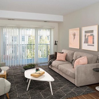 Third North Apartments - A living room with a grey couch, a white coffee table, and a black and white rug - Apartments Near Me - Minneapolis, Minnesota Third North Apartments - A living room with a grey couch, a white coffee table, and a black and white rug - Apartments Near Me - Minneapolis, Minnesota