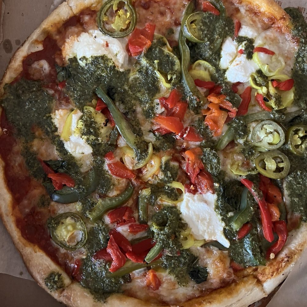 Pizza drowned in pesto sauce that was listed as a drizzle!