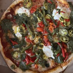 Pizza drowned in pesto sauce that was listed as a drizzle!