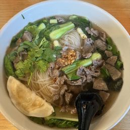Beef broth, beef and meatballs, chicken potsticker, cilantro, basil, and bok choy with rice noodles. Very good