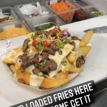 Fye Stars - Loaded fries ... covered in delicious queso blanco, green/red peppers, onions, tomatoes, green onions and chipotle sauce - Food Trucks Near Me - Hollywood, Florida