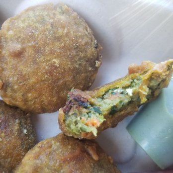 Nirmal's - Bite out of the hara bara tikki appetizer - Indian Near Me - Seattle, Washington