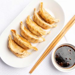 Golden Crispy Pot Stickers (6 pcs) - A bite of perfection! Juicy, flavorful fillings wrapped in a delicate dumpling skin, pan-seared t