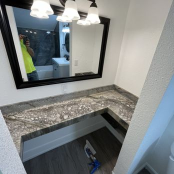 Wards Construction Specialties - a bathroom with a sink and mirror - General Contractors Near Me Wards Construction Specialties - a bathroom with a sink and mirror - General Contractors Near Me