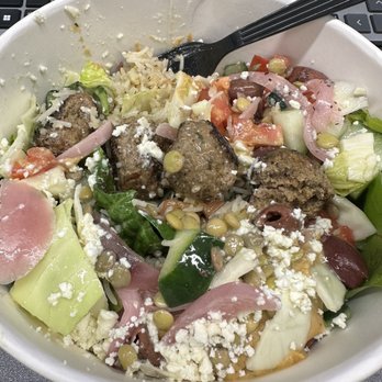 Eliá Athenian Grill - greens and rice as a base, lamb meatballs, red pepper hummus, and then all the veggie toppings, top with lemon tahini dressing - Greek Near Me - Columbus, Ohio Eliá Athenian Grill - greens and rice as a base, lamb meatballs, red pepper hummus, and then all the veggie toppings, top with lemon tahini dressing - Greek Near Me - Columbus, Ohio