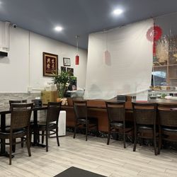Seating and an unused sushi bar. They have an extensive sushi menu, but most foods are ordered to go.