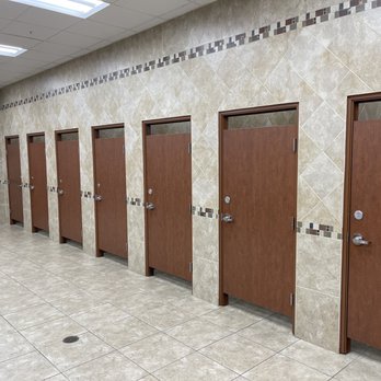 Buc-ee's - a row of wooden doors in a public restroom - Gas Stations Near Me - Leeds, Alabama