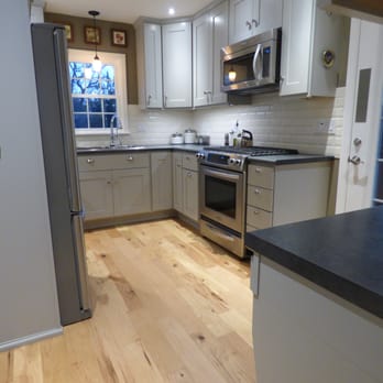 J Christopher Construction - a kitchen with white cabinets and wood floors - General Contractors Near Me J Christopher Construction - a kitchen with white cabinets and wood floors - General Contractors Near Me
