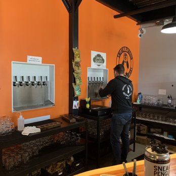 Sneaky Penguin Brewing - a bartender preparing a drink - Breweries Near Me - Raleigh, North Carolina