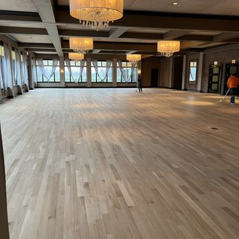 Integrity Flooring - a large empty room with a chandelier - Flooring Near Me Integrity Flooring - a large empty room with a chandelier - Flooring Near Me