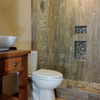 Ezra Builders - a bathroom with a toilet and shower - General Contractors Near Me