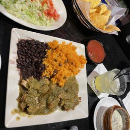 Carnitas verde with side of lettuce and tomato with bowl of espinaca Carnitas verde with side of lettuce and tomato with bowl of espinaca