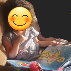 Learning Tree Toys Books & Games - Enjoying her new book, reading to her dolls.