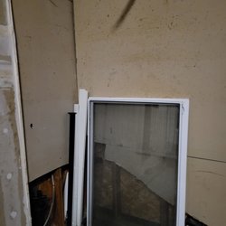 Advantage Property Management - Windows and damage drywall from previous tenants left in garage