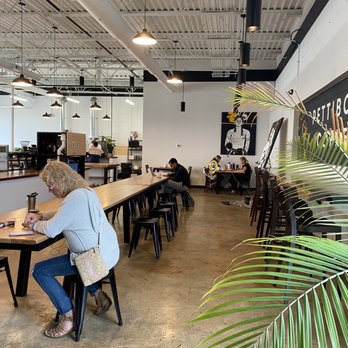 Pettibone Coffee - a woman sitting at a table - Coffee Roasteries Near Me - Dayton, Ohio