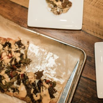 Tecumseh Tavern - a slice of pizza on a plate - Salad Near Me - Tecumseh, Michigan