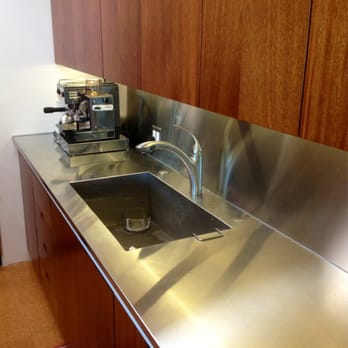 A One Piece Stainless Steel Sink Countertop And Backsplash Were