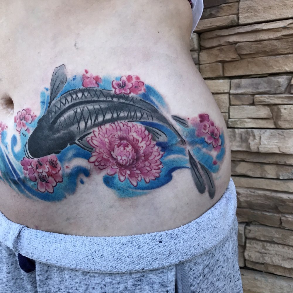Revolt Tattoos - Koi fish and flowers in watercolor to cover my tt scar. I am soooo happy with it!!! - Tattoo Near Me - Las Vegas, Nevada