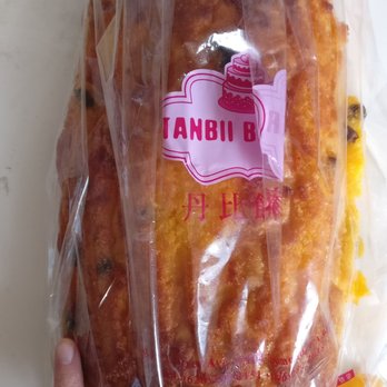 Tanbii Bakery - Coconut raisin bread $4.25. So big!! Look at comparison to my finger. Like 3-4 bread in 1 - Bakeries Near Me - Rosemead, California