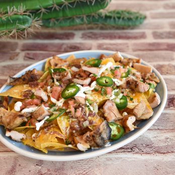 Yummy Tacos - Loaded chicken nachos topped with creamy queso, jalapeños, and fresh toppings--order now from Yummy Tacos in Williston Park NY! - Tacos Near Me - Williston Park, New York Yummy Tacos - Loaded chicken nachos topped with creamy queso, jalapeños, and fresh toppings--order now from Yummy Tacos in Williston Park NY! - Tacos Near Me - Williston Park, New York