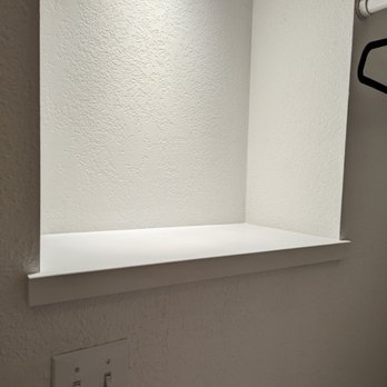 99 Elite Design - After: laundry room wall upgrade, with white quartz on the bottom - Flooring Near Me - Victorville, California