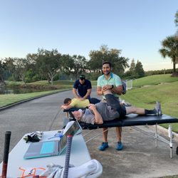 Alliance Regen & Rehab - Dr. John Broussard, DO and Dr. Brian Broussard, DPT warming up golfers for a charity golf tournament at Westchase Golf Club
