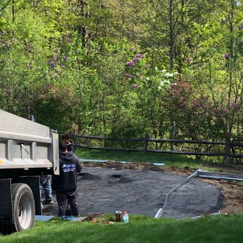 JP Pools - a man standing next to a truck - General Contractors Near Me - Plainville, Connecticut