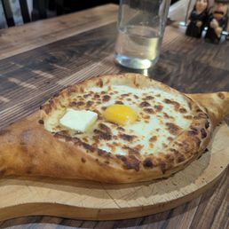 Ajaruli Khachapuri - cheese bread boat with egg and butter Ajaruli Khachapuri - cheese bread boat with egg and butter