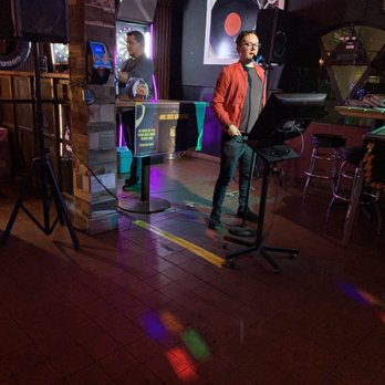 Mic Nite Karaoke - a man standing in front of a microphone - Karaoke Near Me Mic Nite Karaoke - a man standing in front of a microphone - Karaoke Near Me