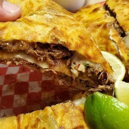 The first slice of birria quesadilla goodness. The first slice of birria quesadilla goodness.