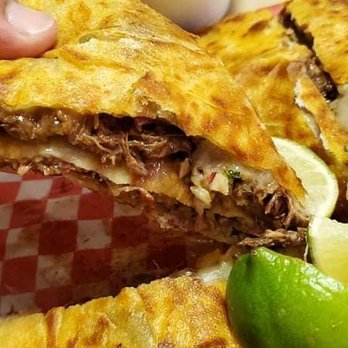 Pollos Asados Don Rafa - The first slice of birria quesadilla goodness. - Mexican Near Me - San Pablo, California Pollos Asados Don Rafa - The first slice of birria quesadilla goodness. - Mexican Near Me - San Pablo, California