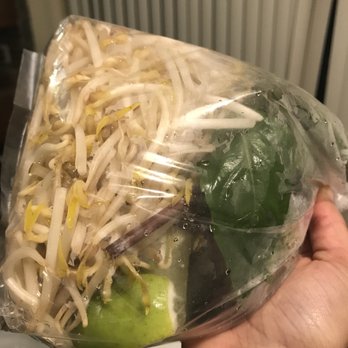 Pho Long Phung - a person holding a bag of food - Vietnamese Near Me - Montreal, Quebec