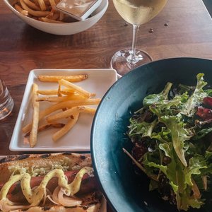 Photo of Borough - Minneapolis, MN, United States. Happy Hour Hot Dog, Mixed Greens, Fries, House Wine