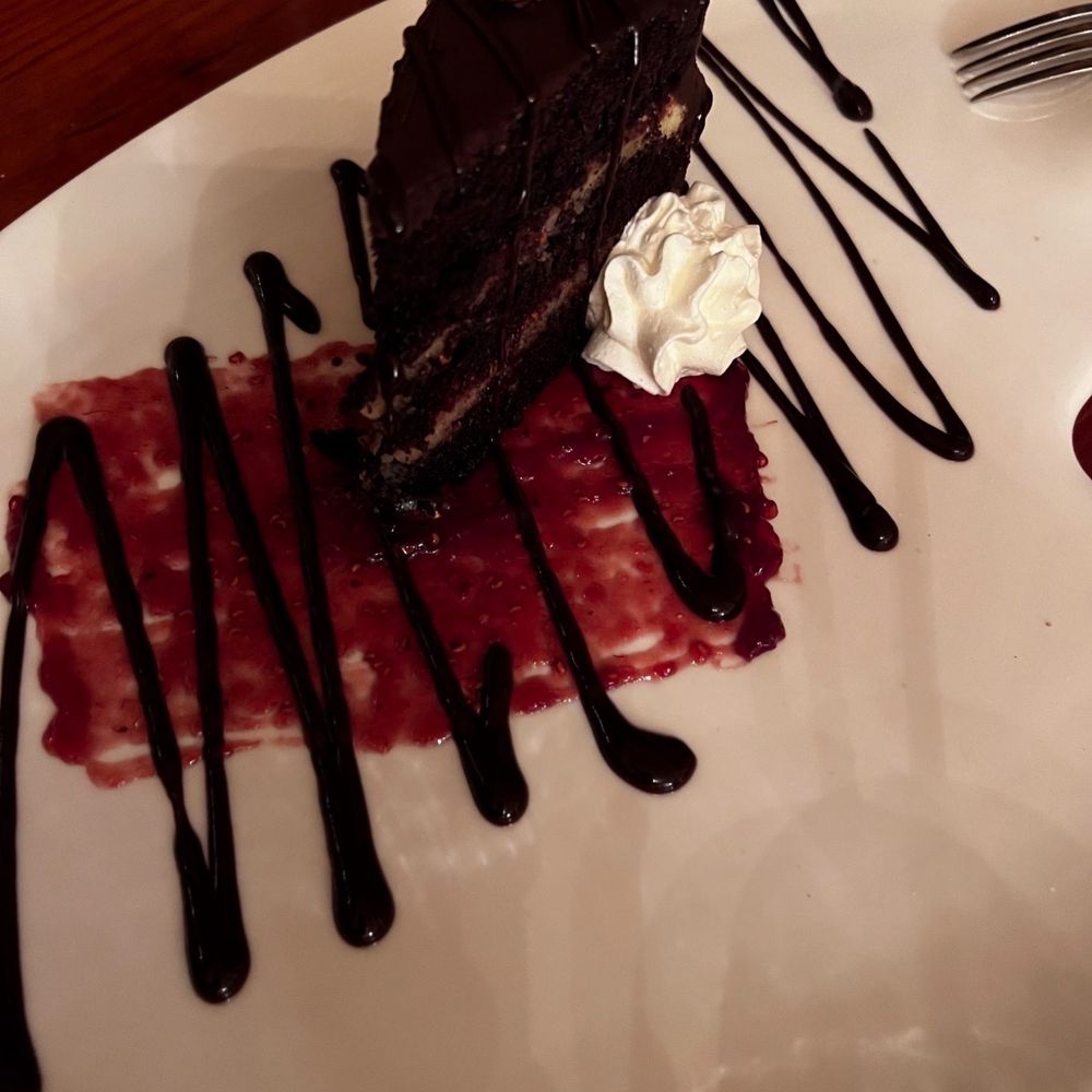 Chez Nous - Flourless chocolate cake with raspberry puree - New American Near Me - Schenectady, New York