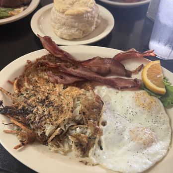 Bisbee Breakfast Club - Potato Cakes with Over Medium Eggs and Bacon - American Near Me - Bisbee, Arizona Bisbee Breakfast Club - Potato Cakes with Over Medium Eggs and Bacon - American Near Me - Bisbee, Arizona