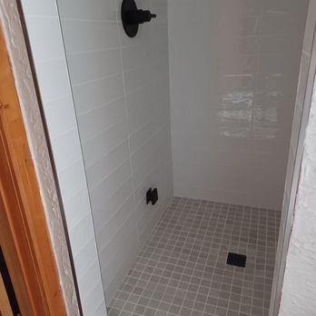 Evergreen Flooring & Tile - a shower with a glass door - Flooring Near Me - Evergreen, Colorado