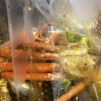 Crack Crab - Springfield - a close up of a crab in a plastic bag - Seafood Near Me - Springfield, Pennsylvania