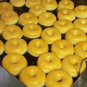 Fresh Donuts - donuts being cooked in a fryer - Donuts Near Me - Corrigan, Texas