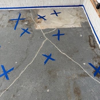 Ohio Basement Authority - Garage floor destroyed by the lifting process. The blue line on the wall is where the lift should have stopped. - Waterproofing Near Me - Obetz, Ohio Ohio Basement Authority - Garage floor destroyed by the lifting process. The blue line on the wall is where the lift should have stopped. - Waterproofing Near Me - Obetz, Ohio