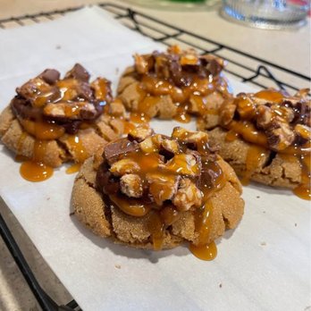 The Cookie Club - Snick snack- peanut butter cookie with soft caramel, chocolate, chopped snickers and of course a caramel drizzle - Desserts Near Me The Cookie Club - Snick snack- peanut butter cookie with soft caramel, chocolate, chopped snickers and of course a caramel drizzle - Desserts Near Me