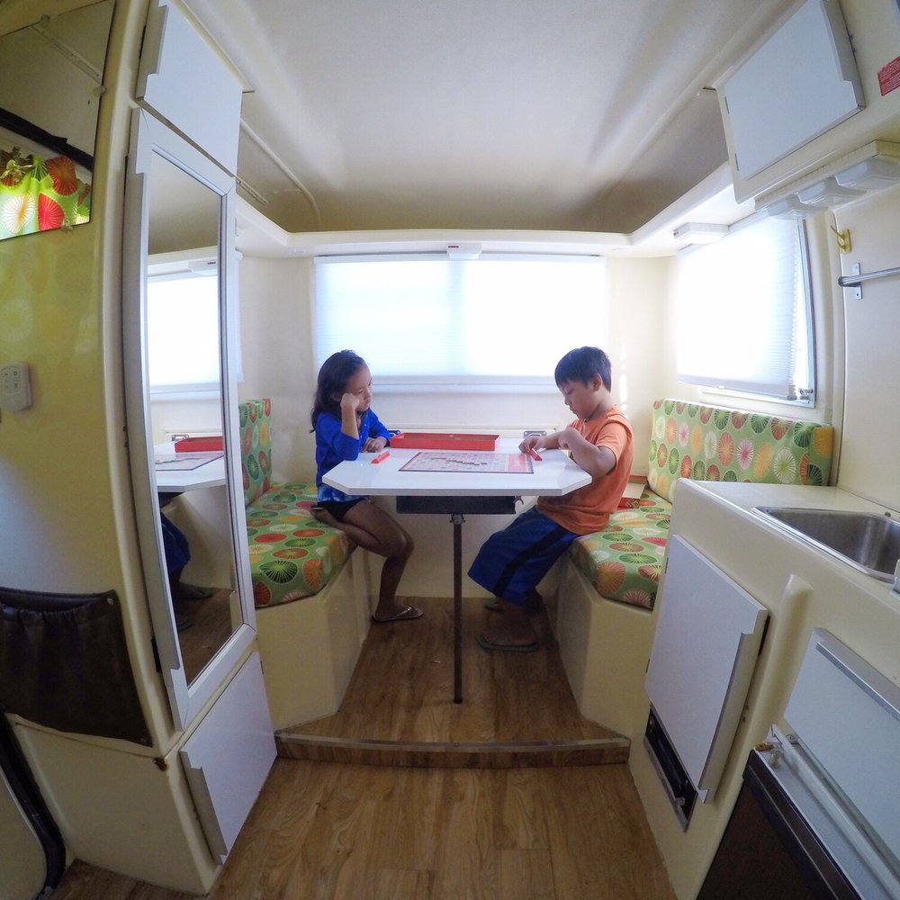 Happier Camper - Small on the outside big on the inside. Kids enjoying a game of scrabble inside the trillium. - Trailer Dealers Near Me - Los Angeles, California Happier Camper - Small on the outside big on the inside. Kids enjoying a game of scrabble inside the trillium. - Trailer Dealers Near Me - Los Angeles, California