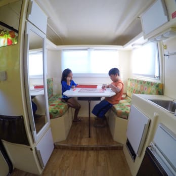 Happier Camper - Small on the outside big on the inside. Kids enjoying a game of scrabble inside the trillium. - Trailer Dealers Near Me - Los Angeles, California Happier Camper - Small on the outside big on the inside. Kids enjoying a game of scrabble inside the trillium. - Trailer Dealers Near Me - Los Angeles, California