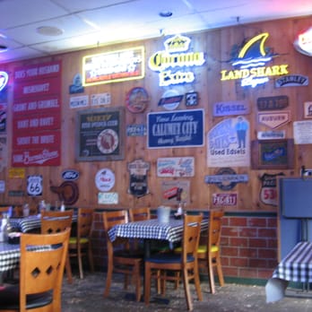 Jake's Roadhouse - The one wall in the dining room with its mixture of signs with sayings, lighted signs, and license plates. - Barbeque Near Me - Monrovia, California Jake's Roadhouse - The one wall in the dining room with its mixture of signs with sayings, lighted signs, and license plates. - Barbeque Near Me - Monrovia, California
