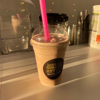 Never Settle Nutrition - a smoothie in a plastic cup with a pink straw - Juice Bars & Smoothies Near Me - Lawton, Oklahoma Never Settle Nutrition - a smoothie in a plastic cup with a pink straw - Juice Bars & Smoothies Near Me - Lawton, Oklahoma