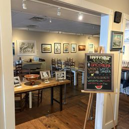 Entrance into the restaurant. Artwork for sale cheers the restaurant walls! Entrance into the restaurant. Artwork for sale cheers the restaurant walls!