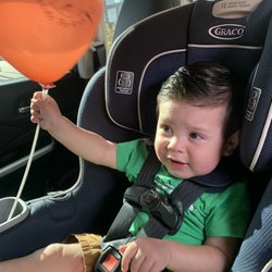 Playing with his balloon after his haircut!